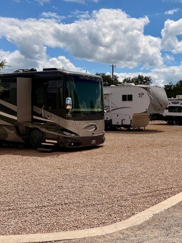 A row of RVs parked in spaces.
