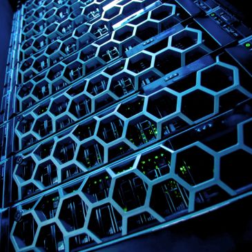 Close-up of a server rack with hexagonal grille design and glowing indicators.