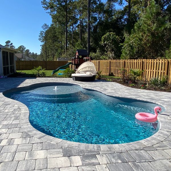 Sun Drenched Pools installation of a San Juan Fiberglass Pool granite Huntington Beach model