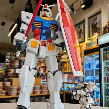 Two Gundam models displayed in a store setting.