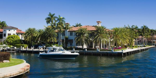 Large house by the water with a boat.