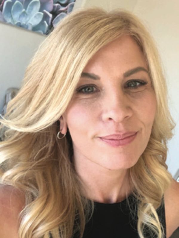 A female insurance agent with blonde hair and blue eyes.