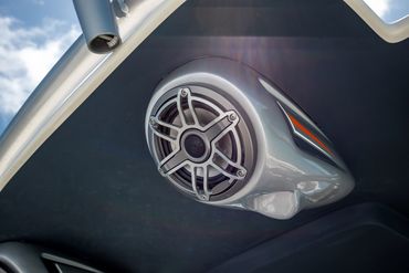 Close-up of a marine speaker mounted on a boat overhead.