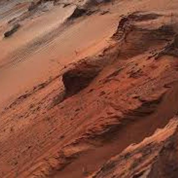 Close-up of textured red rock formations, showing layers and erosion.