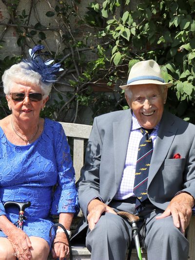 Happy elderly couple relaxing on a park bench