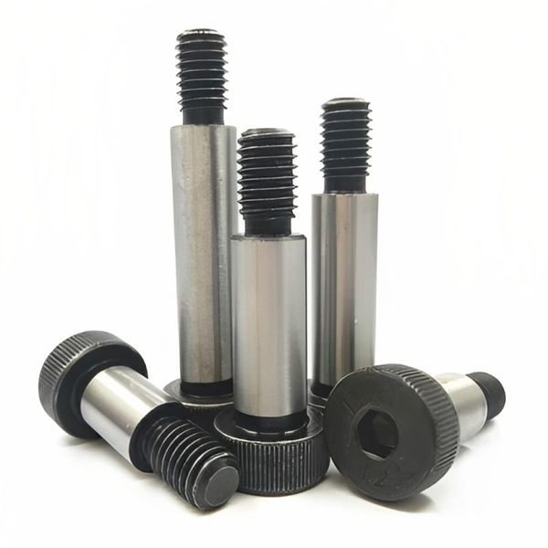 Close-up of five metal shoulder screws with black threaded ends and heads.