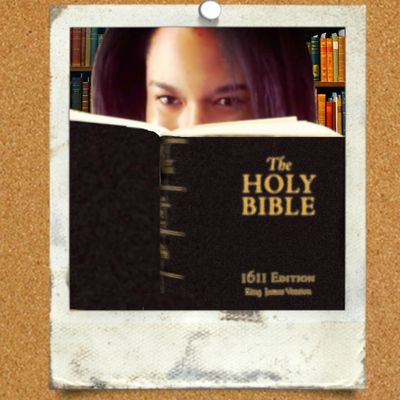 A Polaroid style picture of Leah Judea looking from behind a King James Bible.