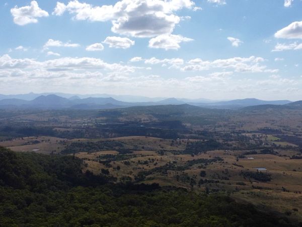 Scenic view of hills and valleys under a blue sky.