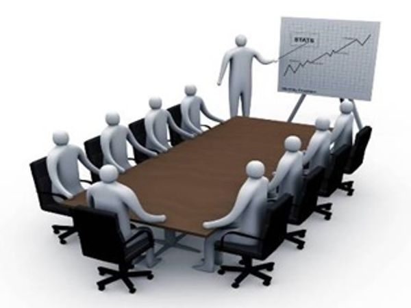 3D figures in a meeting with a presenter showing stats on a board.