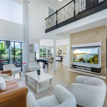 Spacious modern living room with high ceilings and natural light.