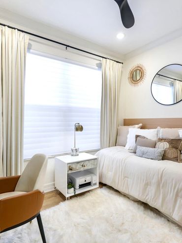 Bright, cozy bedroom with a beige and white color scheme and modern decor.