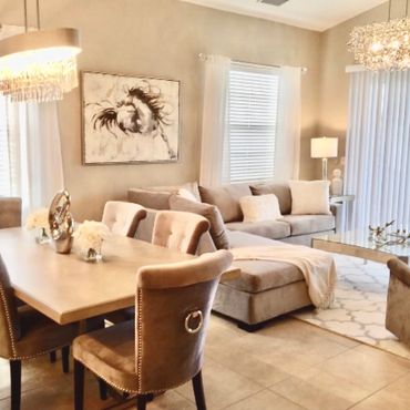 Elegant beige-toned living and dining area with plush seating and modern lighting.