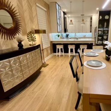 Modern dining area with wooden floor, stylish furniture, and ambient lighting.