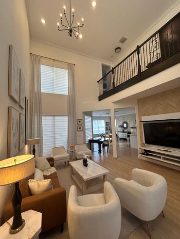 Spacious modern living room with high ceilings and cozy furniture.