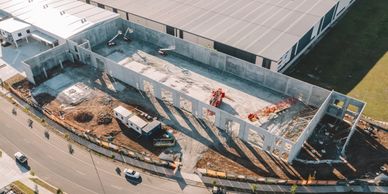 Aerial view of a construction site with concrete walls and equipment.