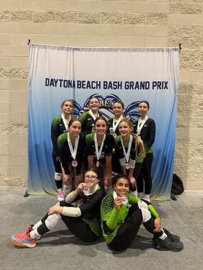 A group of young athletes posing with medals at the Daytona Beach Bash Grand Prix.