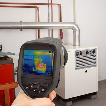 Thermal imaging detects heat emission from a heating system in a utility room.