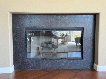 This fireplace surround was done at a minimal cost as we were able to find a remnant to use.