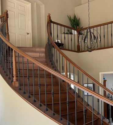 The wood on this staircase was refinished. The ballusters were replaced with wrought iron.