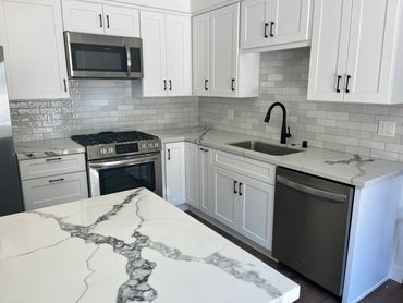 Modern kitchen with quartz countertops. This kitchen was a complete renovation.