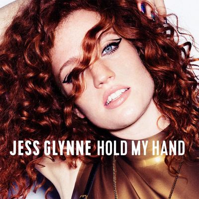 Close-up portrait of Jess Glynne with curly red hair and bold eyeliner.