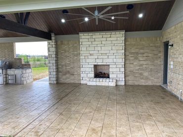 Spacious fireplace patio designed by The Patio Kings