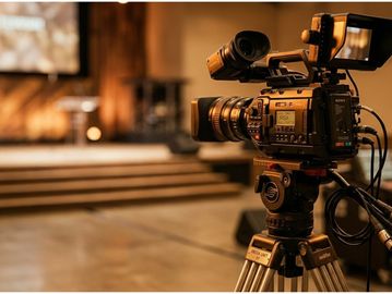 Professional video camera set up for filming indoors.