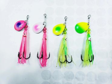 Colorful fishing lures with hooks on a white background.