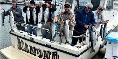 Group of men holding large fish on a fishing boat named Diamond.