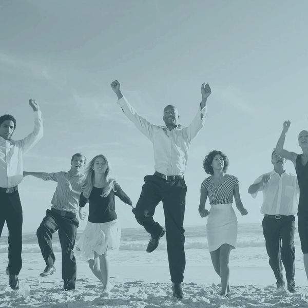 group of business people on the beach celebrating