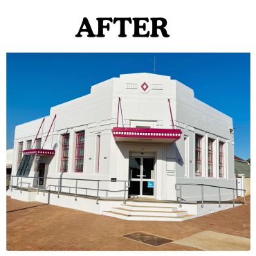 A renovated white building with pink trim and signage.