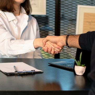 a man shaking hands with a woman in an office