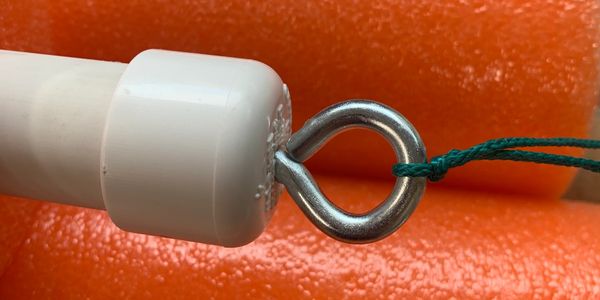 Close up shot of a hook tied by a knot and an orange background