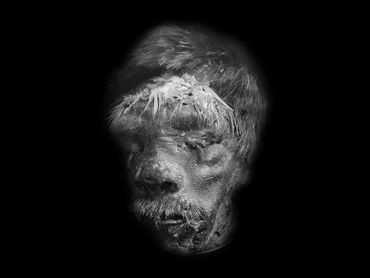 male tourist trade shrunken head with feather headband