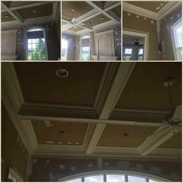 Interior room with coffered ceiling and patched walls under renovation.