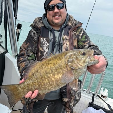 One of our customers holding a Small Mouth Bass around Kelly’s island