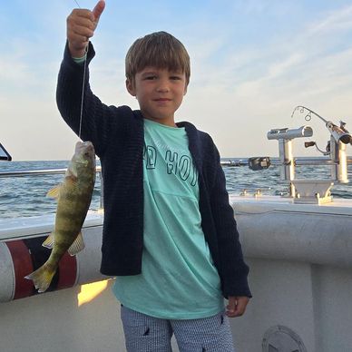 Eby, a young boy holding his first Yellow Perch he caught on Lake Erie