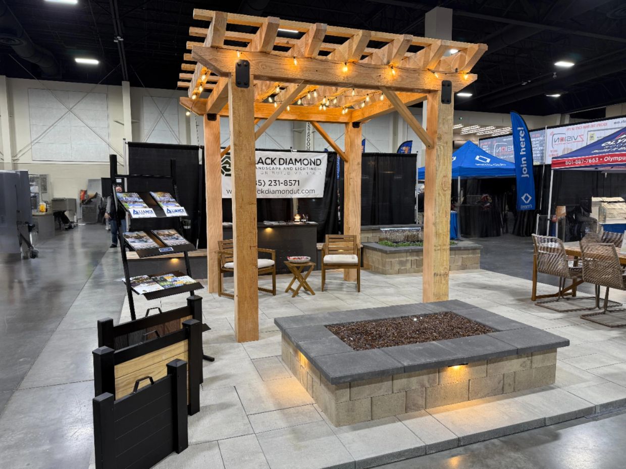 Cedar pergola built by Black Diamond Landscape & Lighting at the Utah Home Show booth.