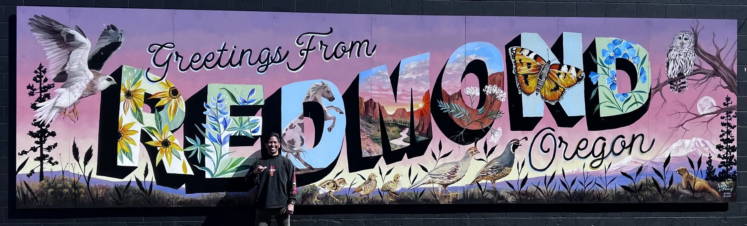 Greetings from Redmond Oregon Mural with Louie Arzaga in the foreground.