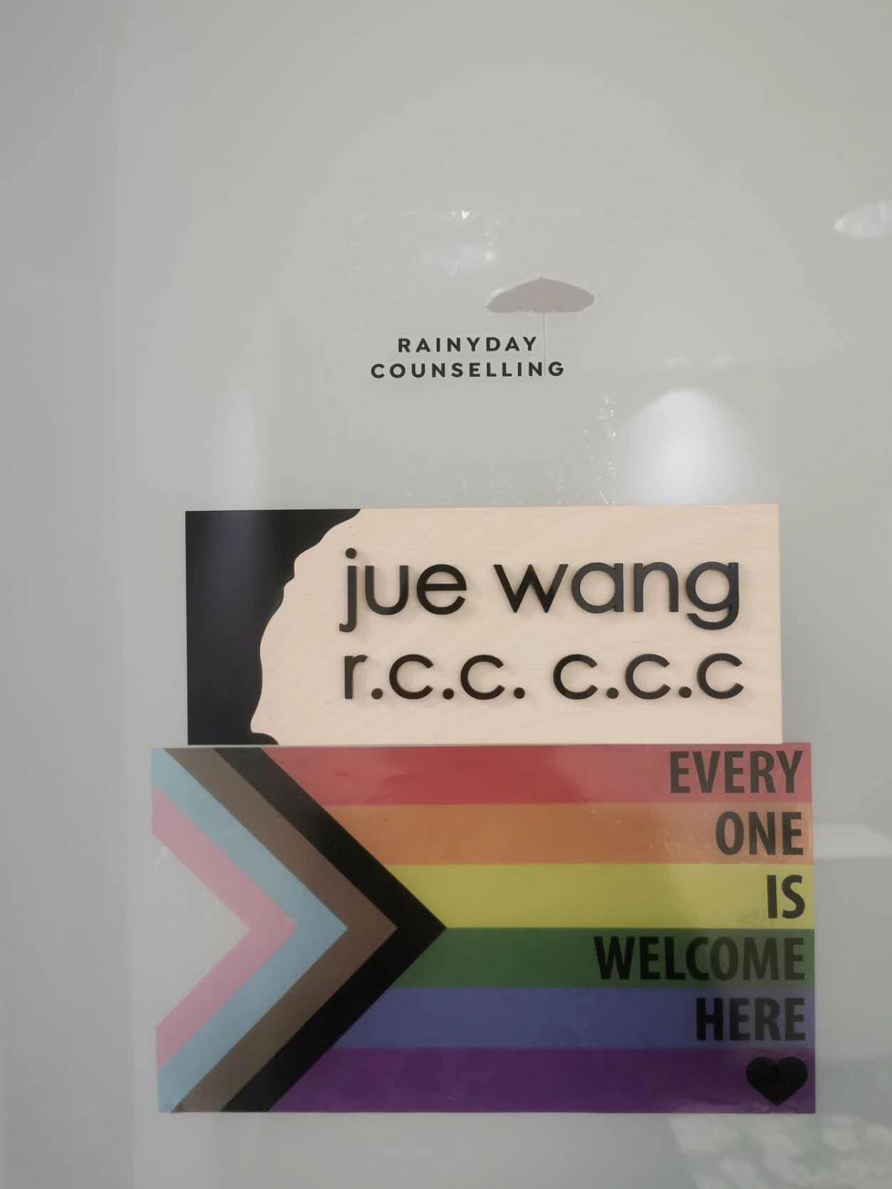 Office door Rainyday Counselling signage, jue wang r.c.c. c.c.c. and LGBTQ2+ rainbow flag sticker