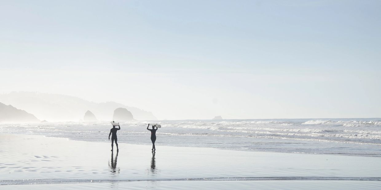 
 Two surfers on Cannon Beach