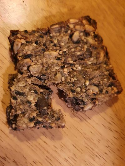 Seedy-cracker-with-sunflower-hemp-sesame-pumpkin-chia-seeds-sundired-tomatoes-on-wooden-surface