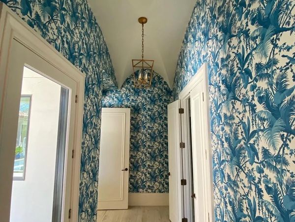 Hallway with blue and white tropical wallpaper