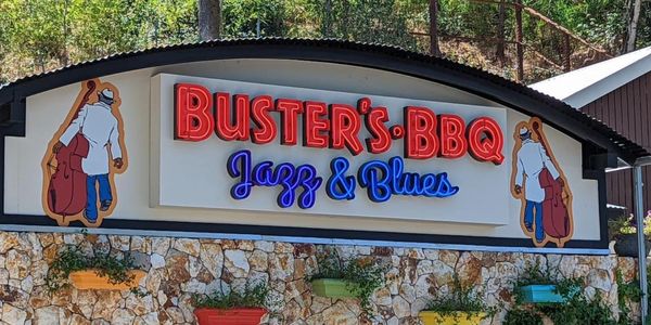 Buster's BBQ Jazz & Blues sign with illustrated musicians.