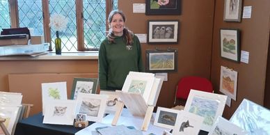 Miranda Whitten-Walker with some of her artwork at an art fair