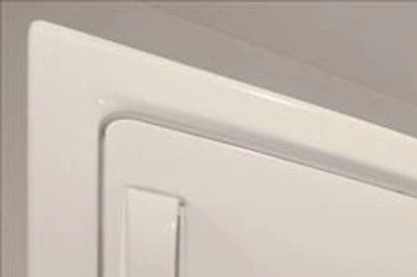 Close-up of a white door corner with a latch.