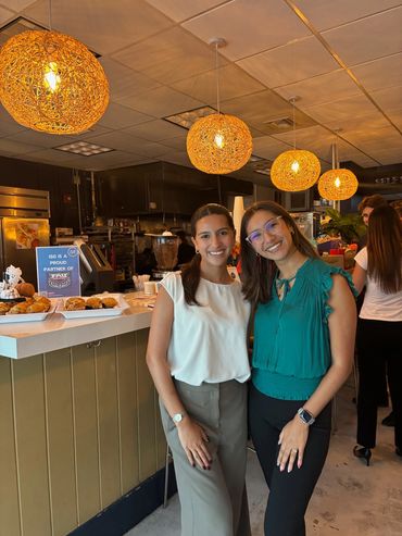 Two female AMA members standing next to each other with their arms around the other.