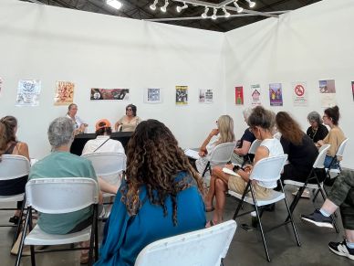 People attending a discussion in a gallery space.