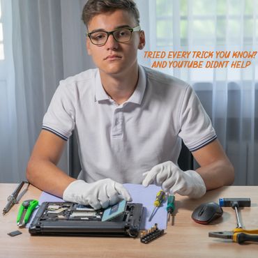Young man repairing a laptop with tools and wearing white gloves.