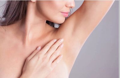 A women looking toward her underarm after laser hair removal